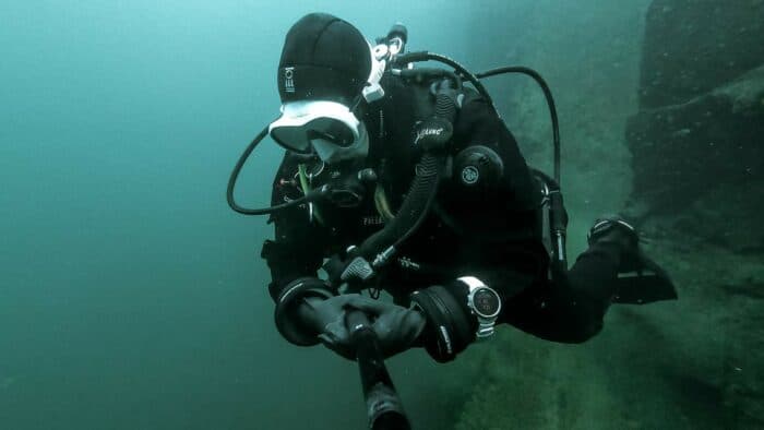 Scuba diver in green water with white mask