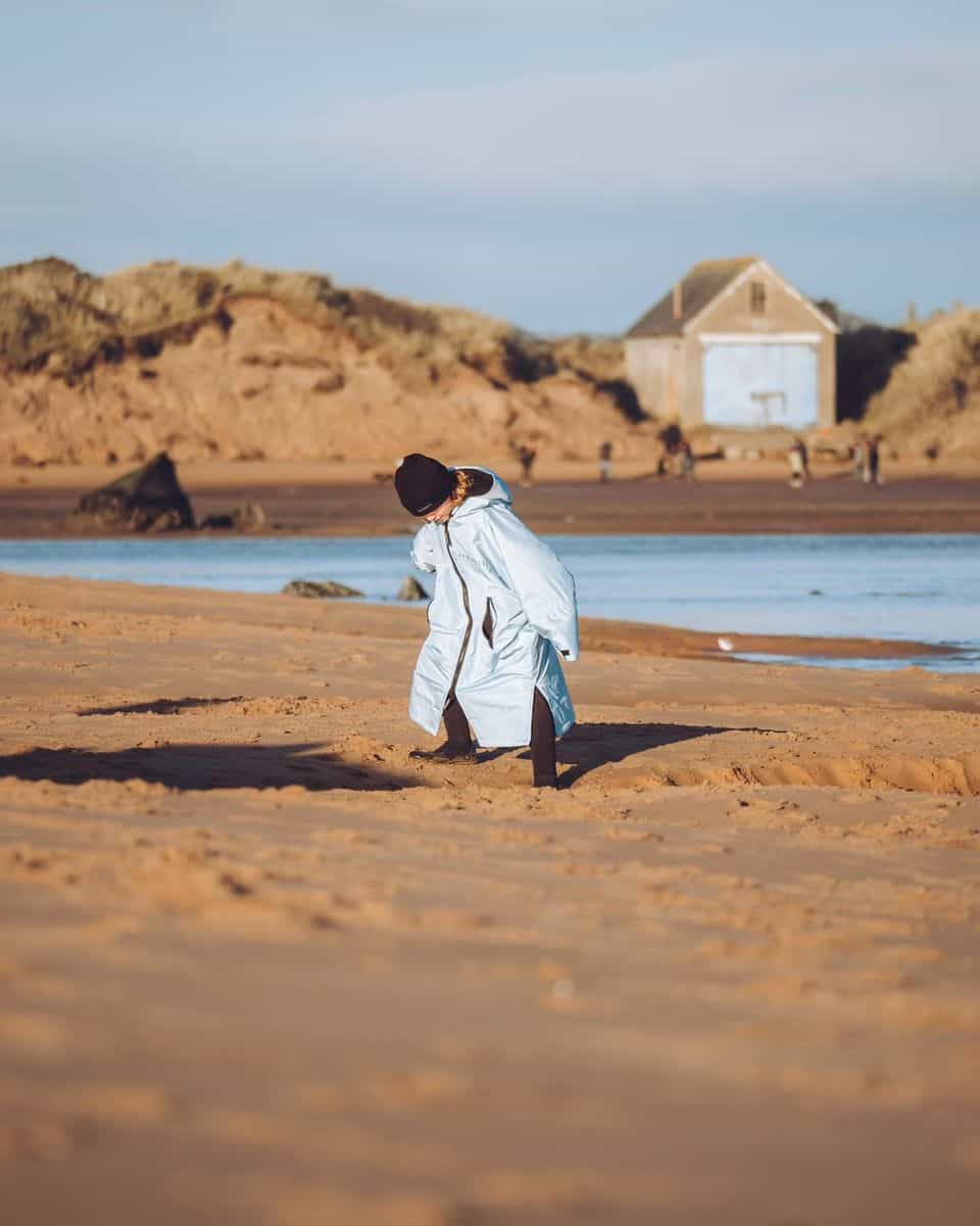 child-on-beach-in-seashell-robe