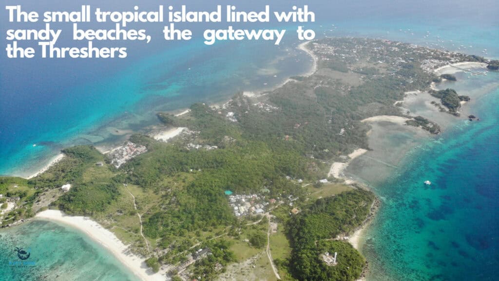 Arial view of small flat island with white sandy beaches and clear blue waters