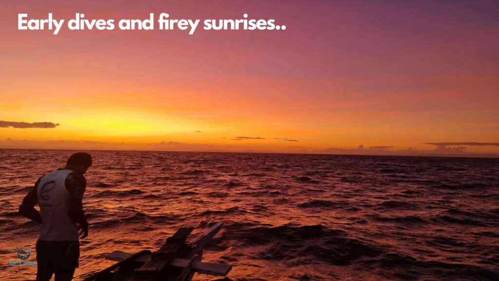 deep orange sunrise over water with man in white vest