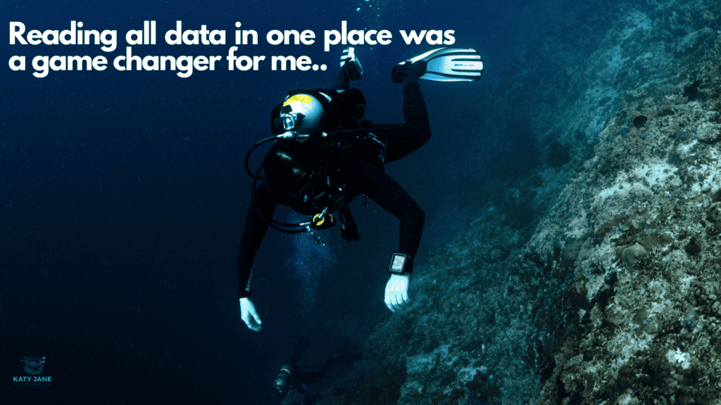 scuba diver floating above reef